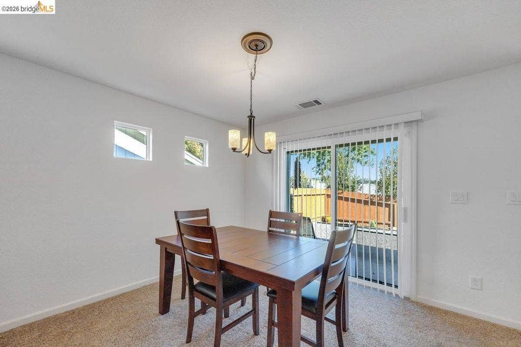 981 Country Ln, Angels Camp, CA 95222 Recessed lighting, square accent windows, and a sliding glass door with vertical blinds