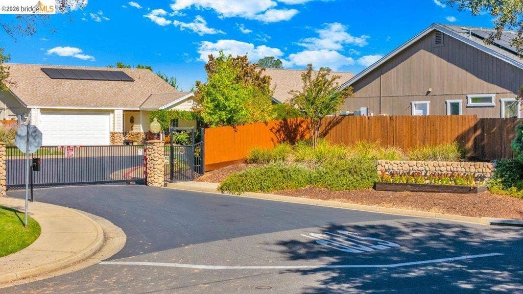 981 Country Ln, Angels Camp, CA 95222 Gated entry with stone columns and wrought iron fencing