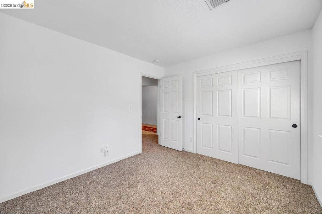 981 Country Ln, Angels Camp, CA 95222 Light-colored carpet, white walls, and a white six-panel closet door