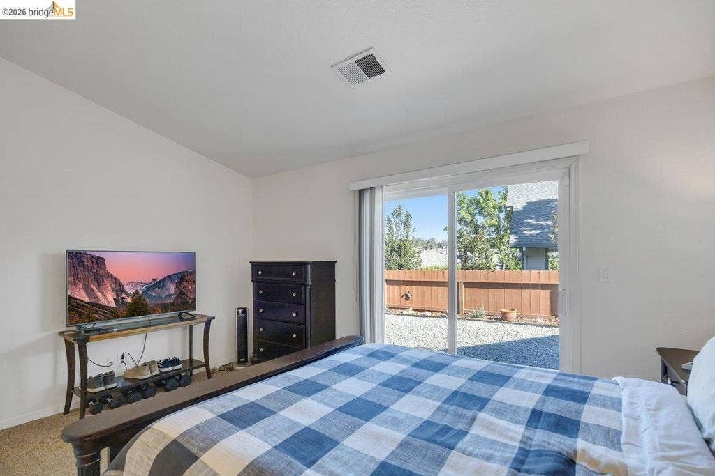 981 Country Ln, Angels Camp, CA 95222 Sliding glass door, light neutral wall color, recessed lighting, privacy fencing, gravel hardscaping
