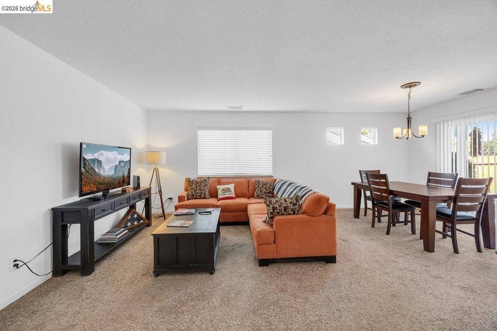 981 Country Ln, Angels Camp, CA 95222 Open-concept living area with carpet flooring and ample natural light