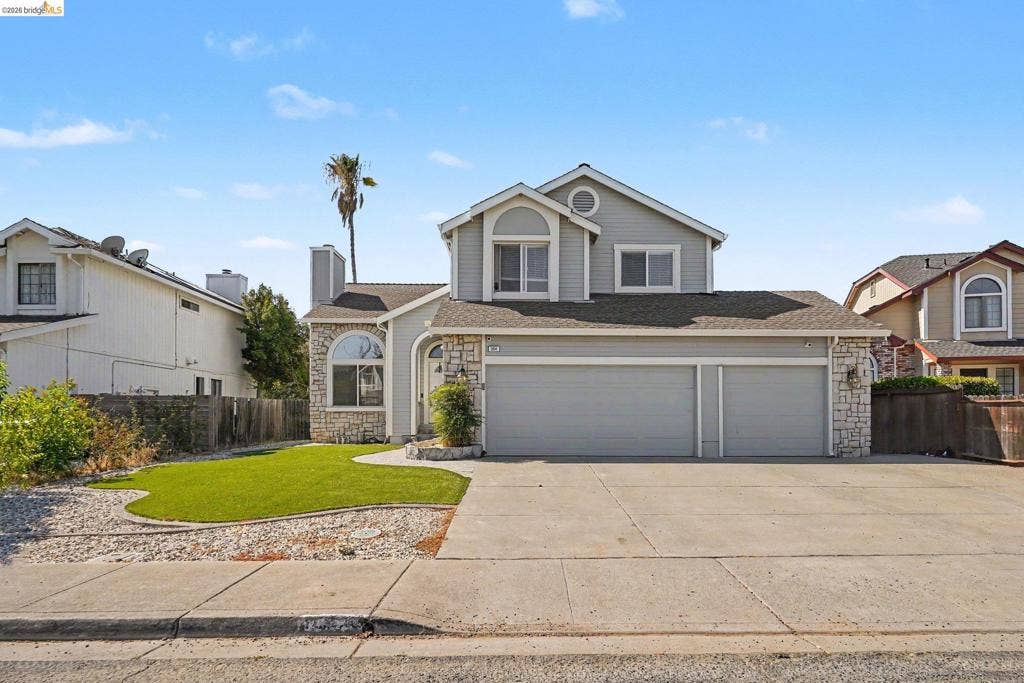 304 Greystone Dr, Antioch, CA 94509 Multi-level exterior featuring stone veneer accents, lap siding, two-car garage, and a concrete driveway