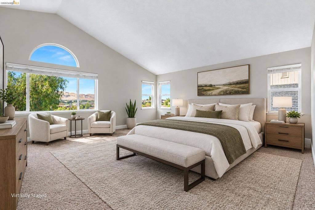 304 Greystone Dr, Antioch, CA 94509 Vaulted ceilings with a semi-circular transom window, neutral wall palette, carpeting, and multiple windows providing natural light