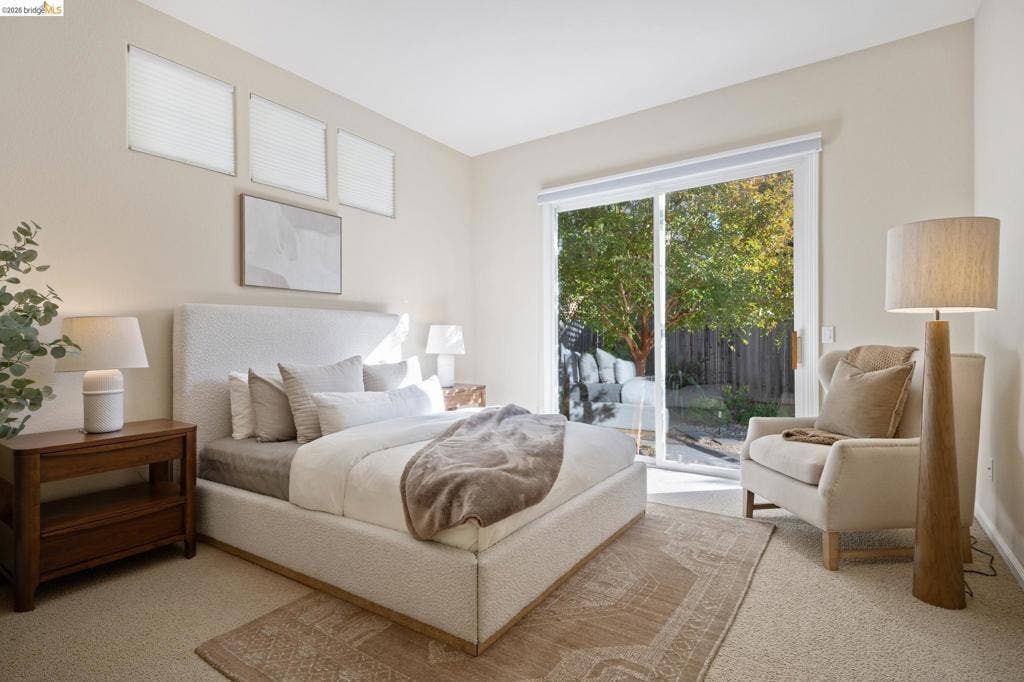 5503 Rainbow Cir, Santa Rosa, CA 95409 Neutral interior featuring carpeted flooring, three high-placed rectangular windows, and large sliding glass doors