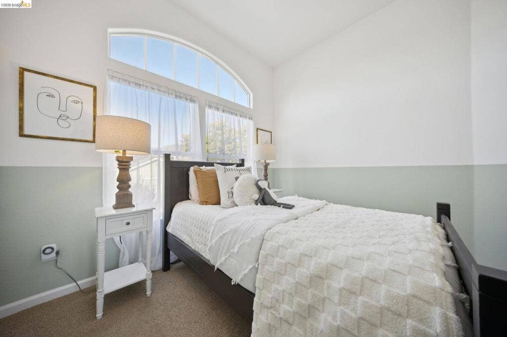 5503 Rainbow Cir, Santa Rosa, CA 95409 Arched window, dual-tone wall paint, and neutral carpeting