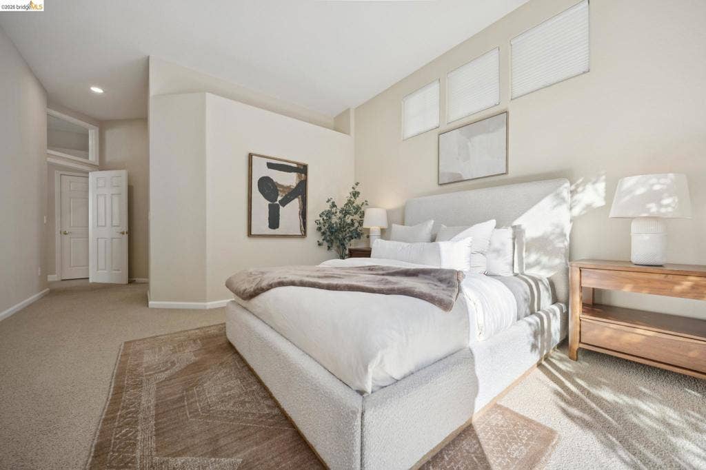 5503 Rainbow Cir, Santa Rosa, CA 95409 Neutral-toned interior space featuring carpeted flooring, high ceilings with recessed lighting, three upper-level transom windows, and a multi-panel interior door