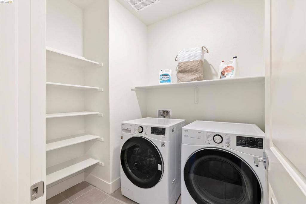 539 Gemstone Way, Oakley, CA 94561 Dedicated utility space featuring built-in shelving, a wall-mounted storage shelf, and tile flooring