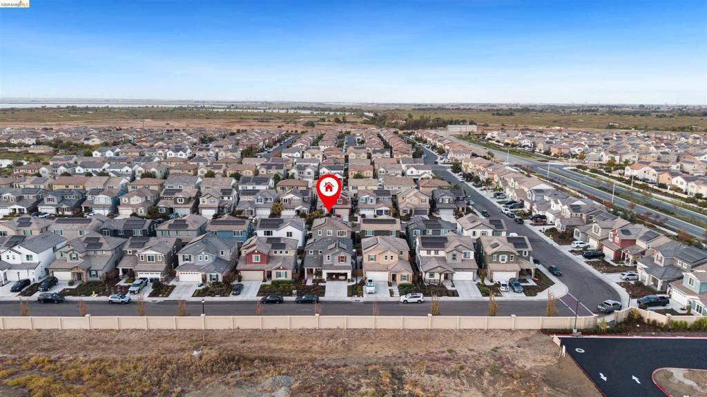 539 Gemstone Way, Oakley, CA 94561 Aerial perspective of a multi-story residential property featuring a composition shingle roof, solar panel array, attached garage, and paved driveway