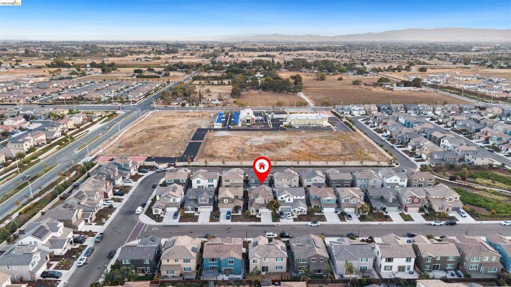 539 Gemstone Way, Oakley, CA 94561 Aerial perspective featuring a multi-story residential structure with an attached garage, shingled roofing, and a private rear yard in a suburban setting