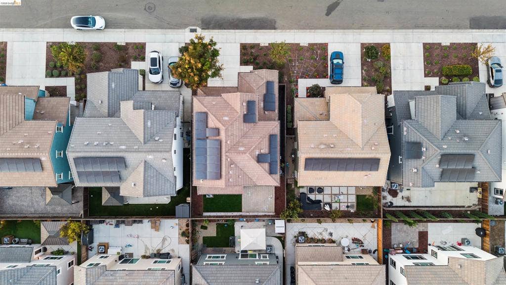 539 Gemstone Way, Oakley, CA 94561 Aerial view featuring multiple residences with tile roofing, integrated solar panel systems, concrete driveways, and backyards with a mix of hardscaping and lawn areas