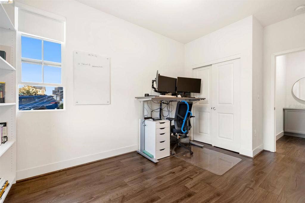 539 Gemstone Way, Oakley, CA 94561 Room featuring wood-finish flooring, built-in shelving, a single-hung window with a roller shade, and a double-door closet