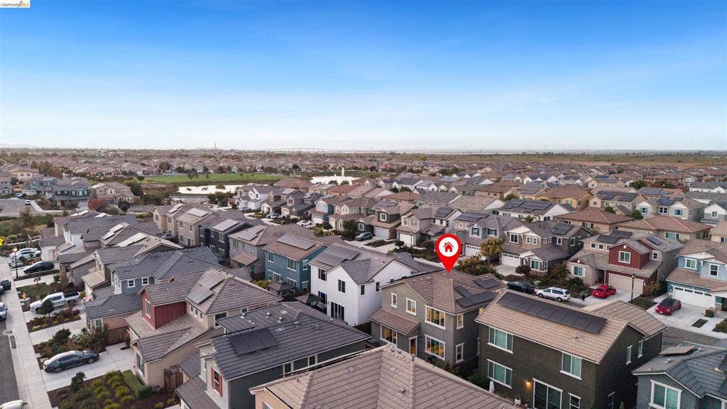 539 Gemstone Way, Oakley, CA 94561 Aerial perspective of a multi-story residence featuring a pitched roofline, integrated solar panels, stucco exterior, and multi-pane windows