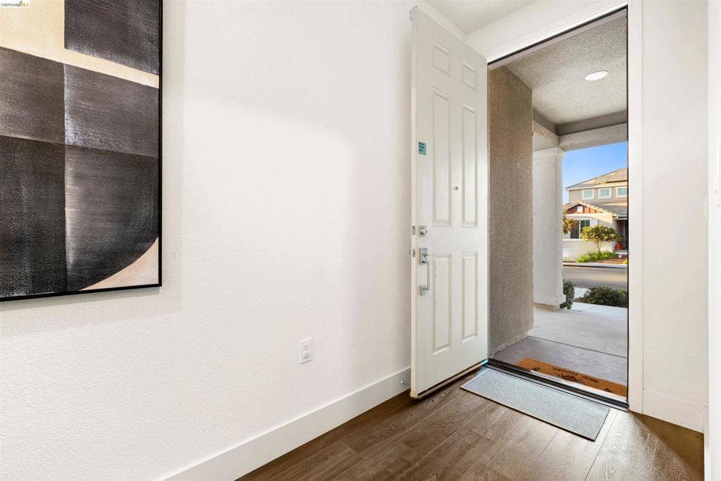 539 Gemstone Way, Oakley, CA 94561 Entryway featuring a six-panel door, wood-finish flooring, and recessed ceiling lighting