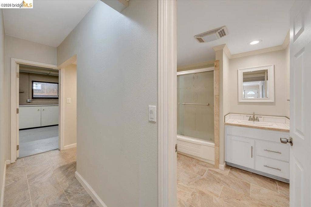 5827 Lookout Ct, CA 95233 Bathroom featuring white cabinetry, stone-finish countertop, integrated sink, tiled shower enclosure, and neutral-tone flooring