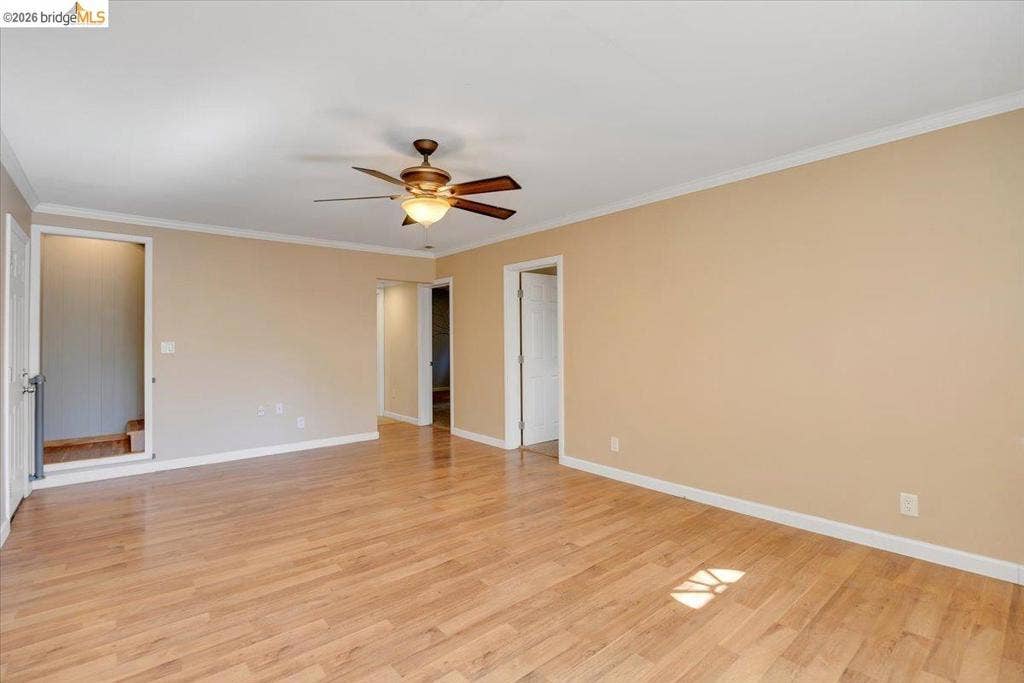 5827 Lookout Ct, CA 95233 Interior space featuring wood-finish flooring, neutral wall paint, and a ceiling-mounted light fixture with a fan