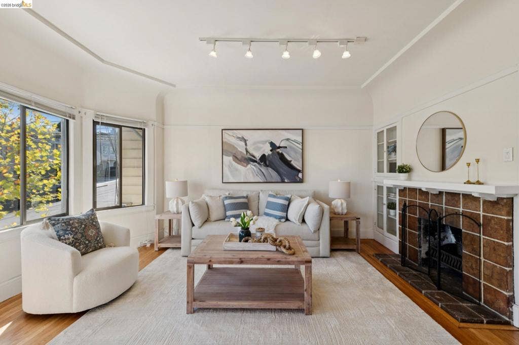 715 17Th Ave, San Francisco, CA 94121 a tile-surround fireplace with a mantel, built-in glass-front cabinetry, curved architectural detailing