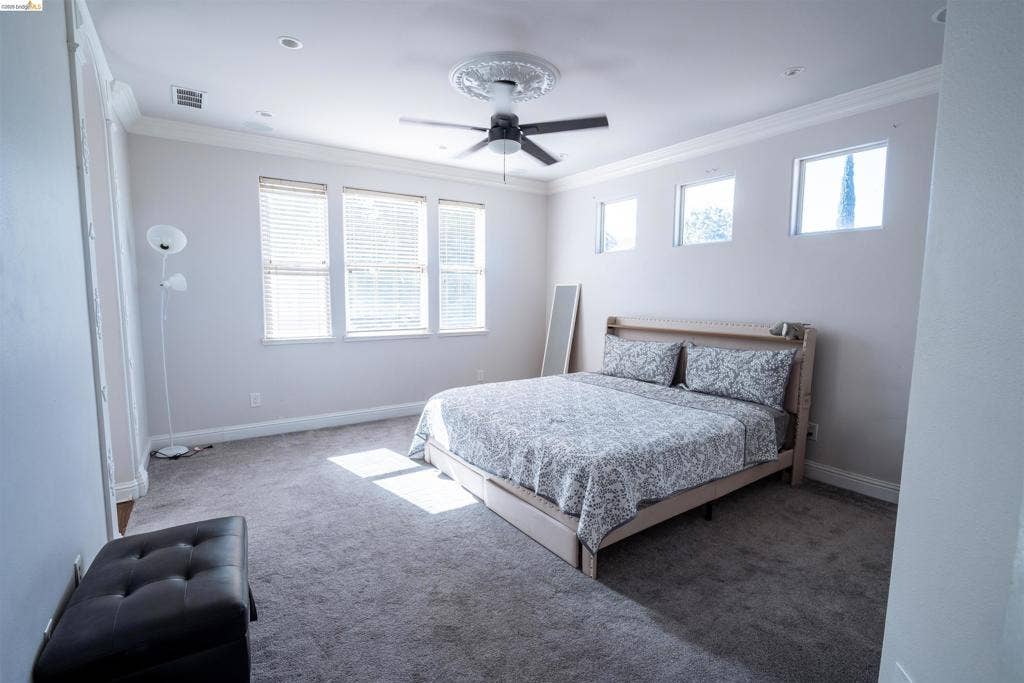 4600 Via Terreno, Modesto, CA 95357 Spacious interior featuring neutral wall tones, decorative ceiling medallion, integrated ceiling fan, crown molding, and high-placed windows