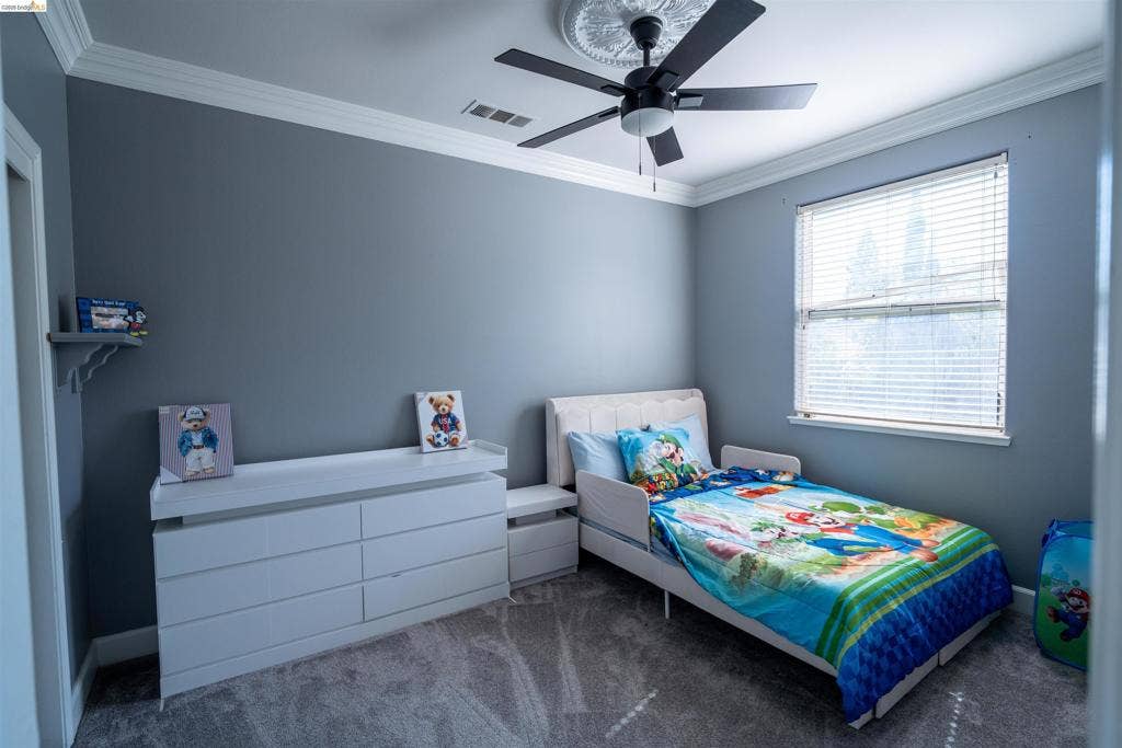4600 Via Terreno, Modesto, CA 95357 Room featuring neutral wall tones, crown molding, ceiling medallion, ceiling fan, and carpeted flooring