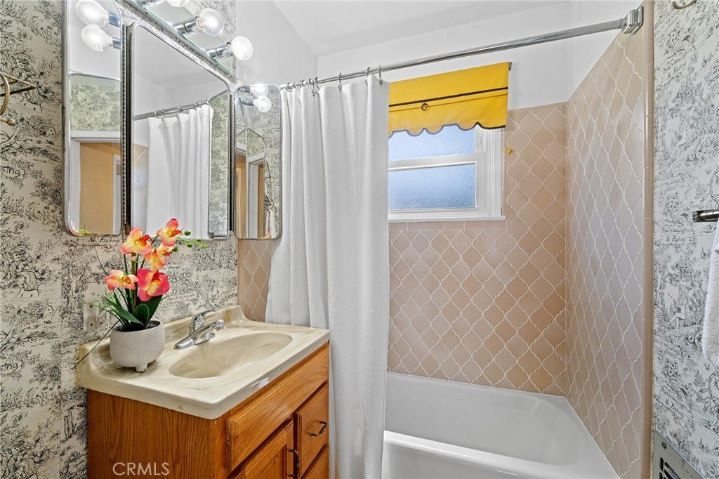 604 N Charter, Covina, CA 91724 Full bath with well cared for tile in the shower/tub area. Wallpaper is cute.