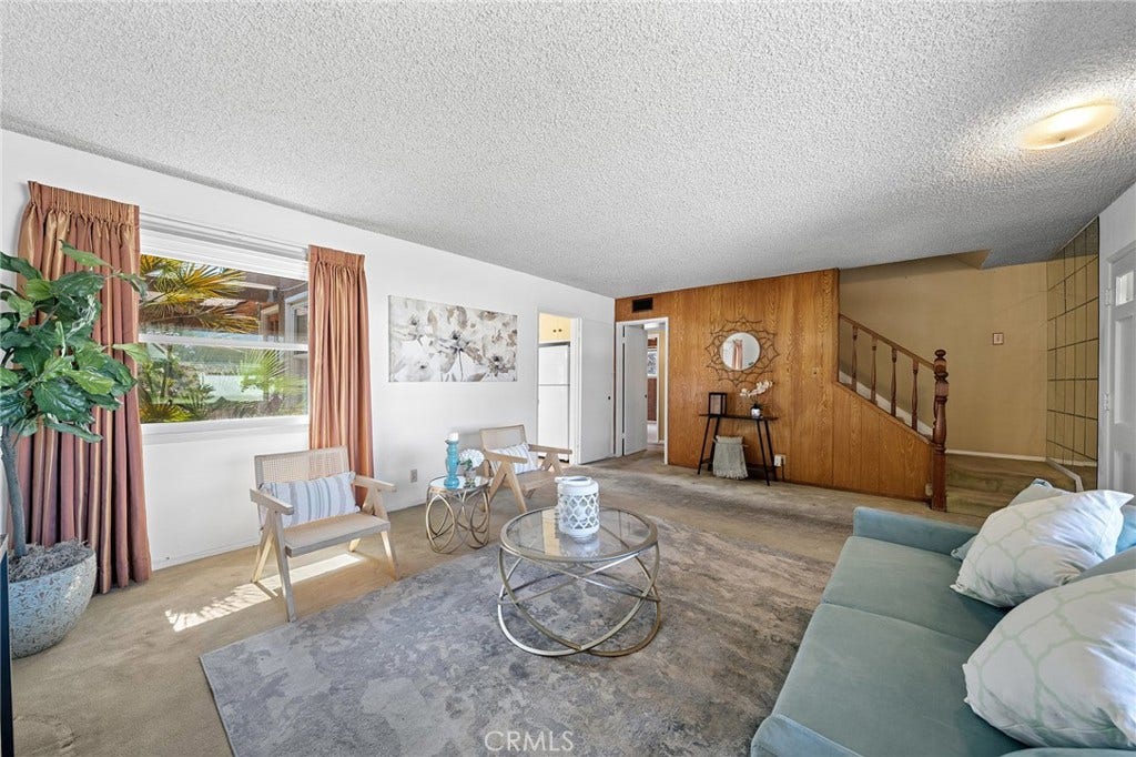 604 N Charter, Covina, CA 91724 There is hardwood under the carpet. Window faces the backyard/covered patio. Stairs lead to two of four bedrooms and 3/4 bathroom. The hallway between stairs and kitchen lead to two lower bedrooms and one full bath.