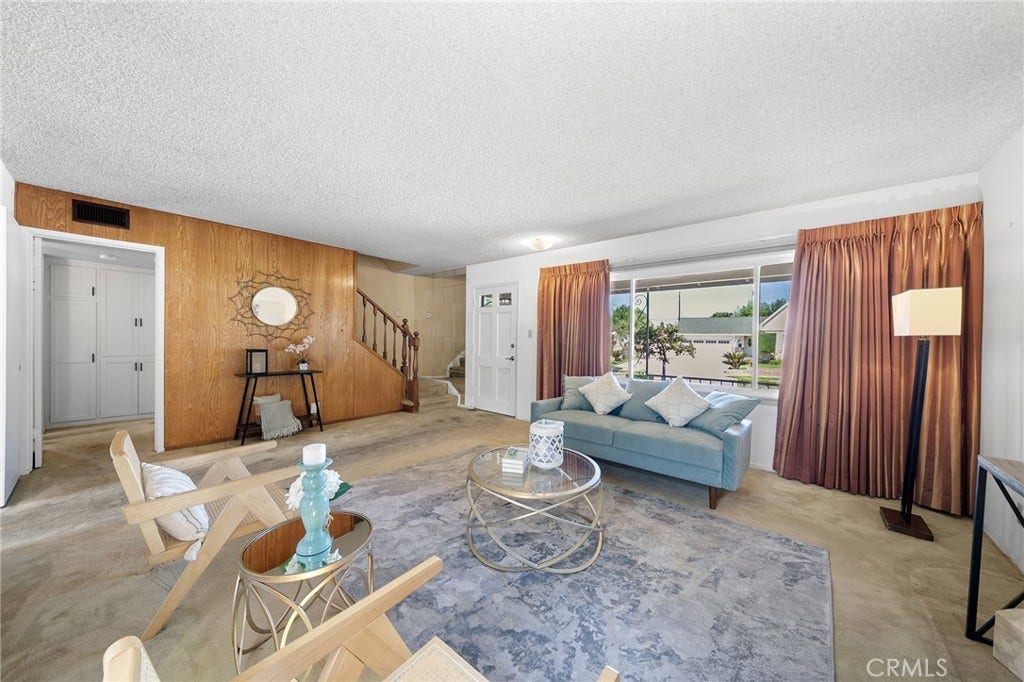 604 N Charter, Covina, CA 91724 There is hardwood under the carpet. Window faces the front yard. Stairs lead to two of four bedrooms and 3/4 bathroom. The hallway between stairs and kitchen lead to two lower bedrooms and one full bath.