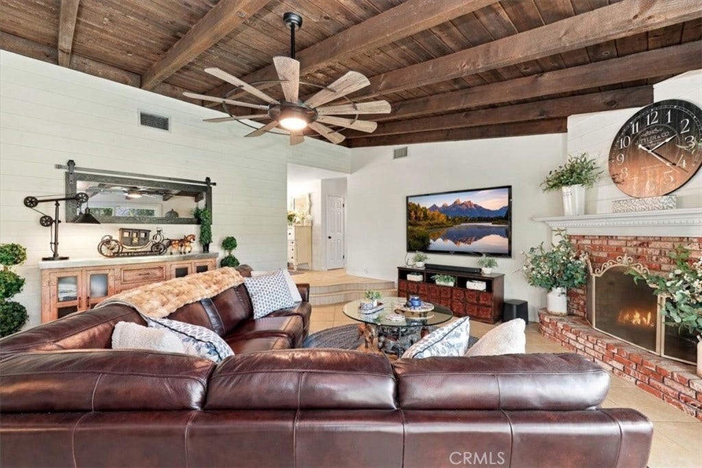 2791 Bronco Lane, Norco, CA 92860 Family room includes rustic beams and an inviting gar fireplace