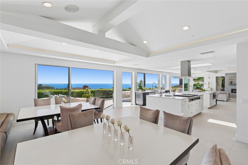 Designed for seamless indoor outdoor living and effortless entertaining, the open-concept interiors are bathed in natural light, while expansive glass doors frame the coastal landscape and open the main living area to a spacious ocean view deck.