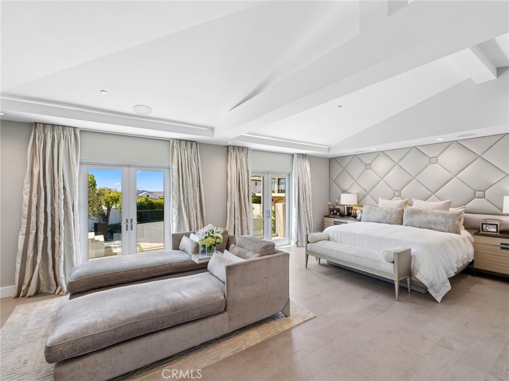 The main level features a generously proportioned primary suite and two private offices, offering the convenience of single-level living.