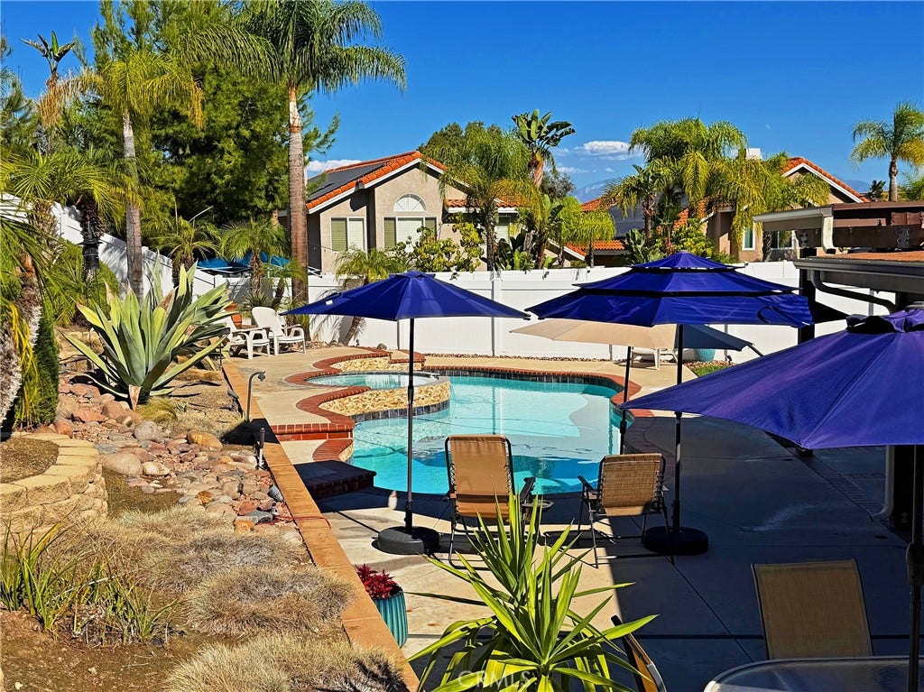 2400 Pepperwood, Corona, CA 92882 Vacation-at-home living with a spacious pool area surrounded by mature landscaping and open outdoor space.