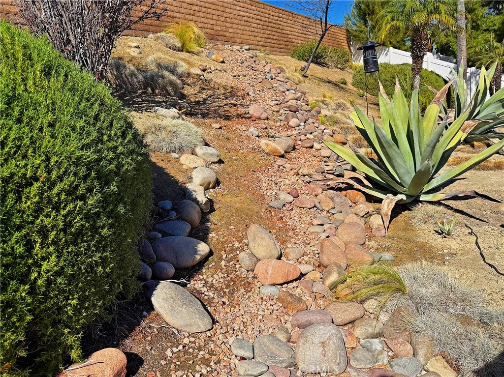2400 Pepperwood, Corona, CA 92882 Low-maintenance landscaping with mature plants, decorative rock, and drip irrigation throughout portions of the property.