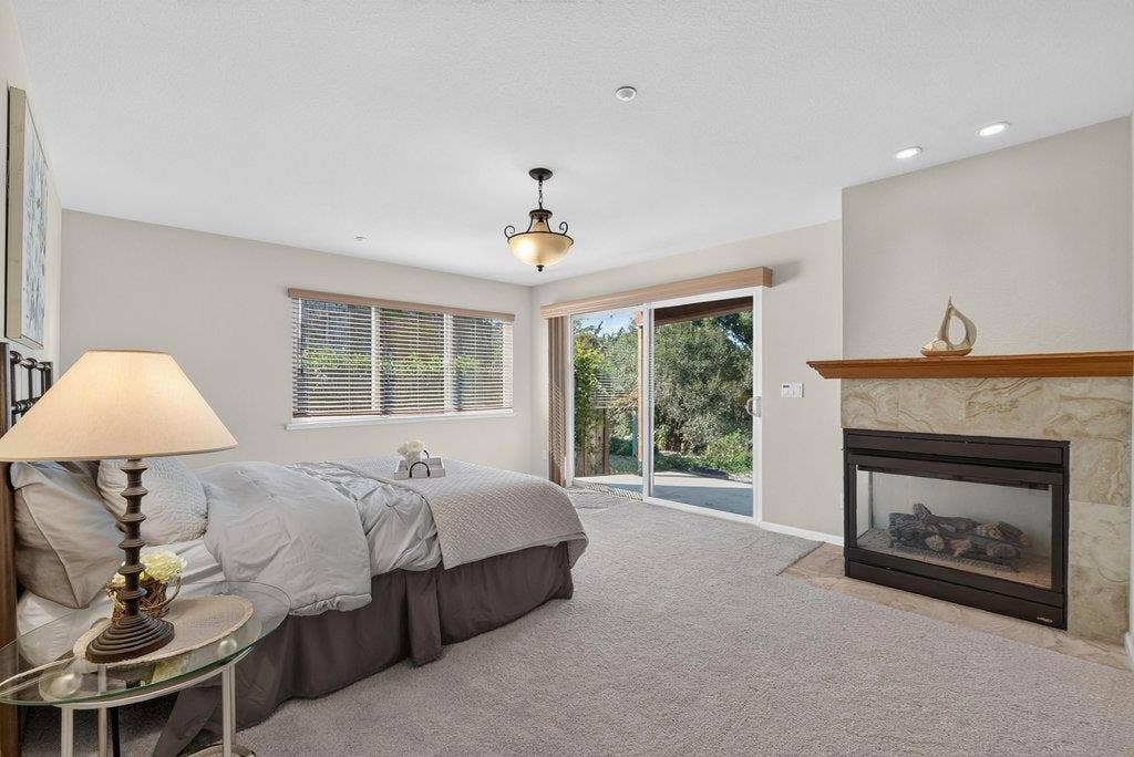 110 Mattison Court, Aptos, CA 95003 Primary bedroom with fireplace and sliding door to the concrete patio.