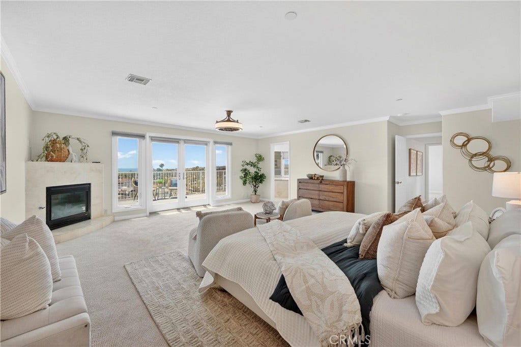 Primary suite with fireplace and ocean views