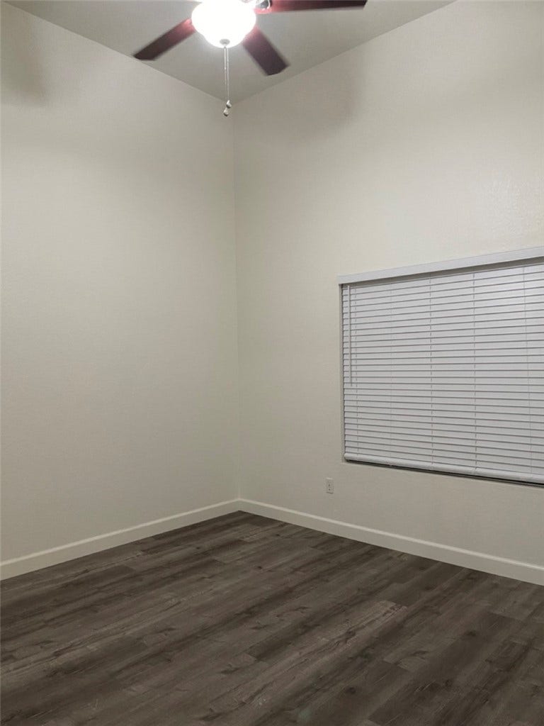 Primary Bedroom with vaulted ceilings and window that open to patio