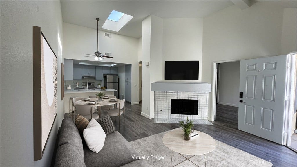 Virtually Staged Photo - Open Floor Plan. TV mount over Fireplace.