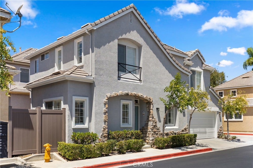 15 Poppyfield, Rancho Santa Margarita, CA 92688 Corner perspective highlighting the home's detached design, stone-accented entry, and desirable end-unit location.