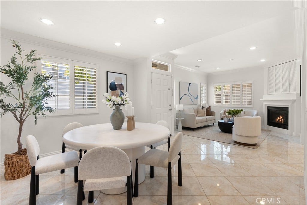 15 Poppyfield, Rancho Santa Margarita, CA 92688 The open-concept floor plan seamlessly connects the dining area and living room, offering abundant natural light and an ideal space for gathering with family and friends.