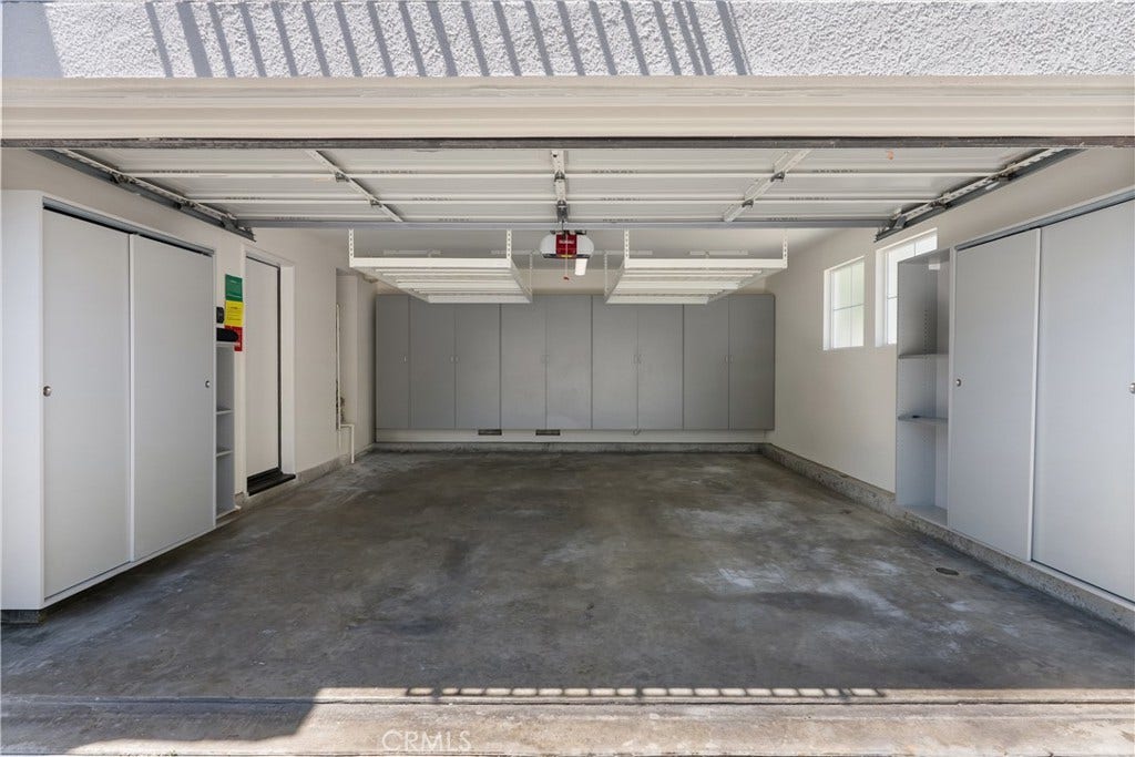 15 Poppyfield, Rancho Santa Margarita, CA 92688 The finished two car garage is exceptionally well organized with extensive built in cabinetry, overhead storage racks, and durable storage systems, providing plenty of space for vehicles, tools, hobbies, and seasonal items.