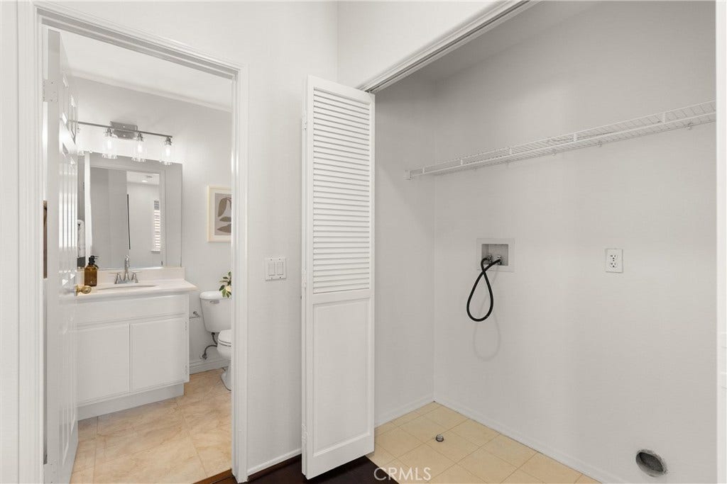 15 Poppyfield, Rancho Santa Margarita, CA 92688 Laundry area with built in shelving and washer and dryer hookups offers exceptional flexibility, making it ideal for multi generational living, guests, or added household convenience.