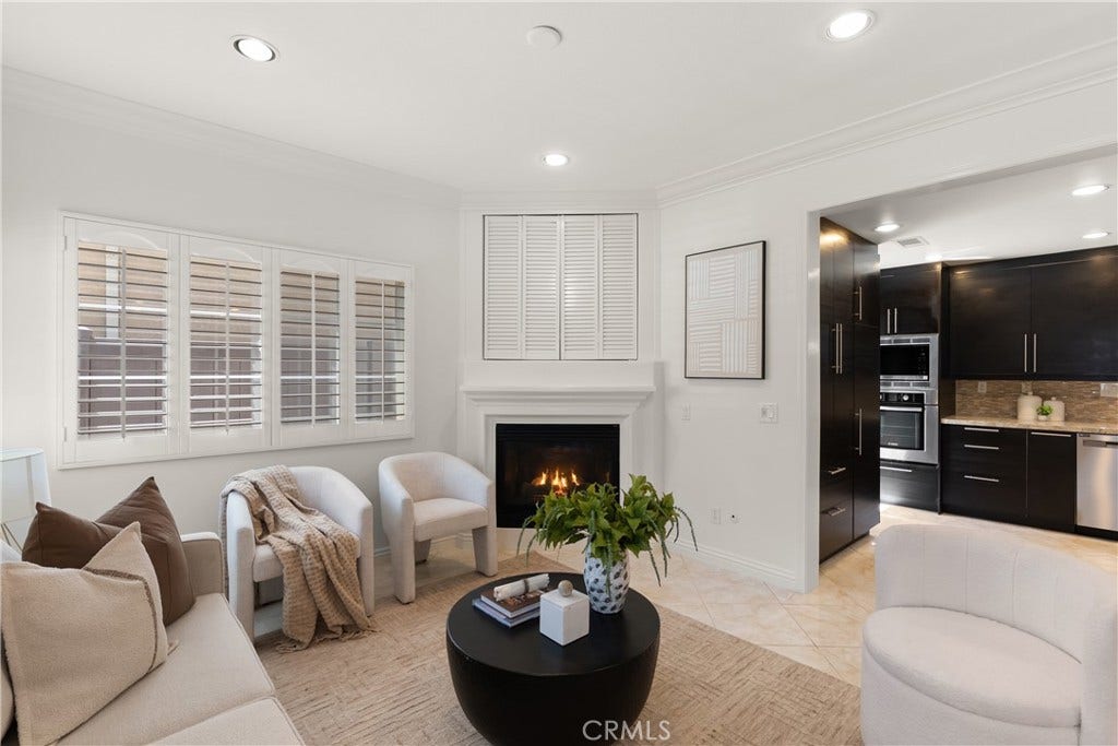 15 Poppyfield, Rancho Santa Margarita, CA 92688 Spacious living area centered around a gas fireplace with elegant mantel, complemented by abundant natural light and an open flow into the kitchen.