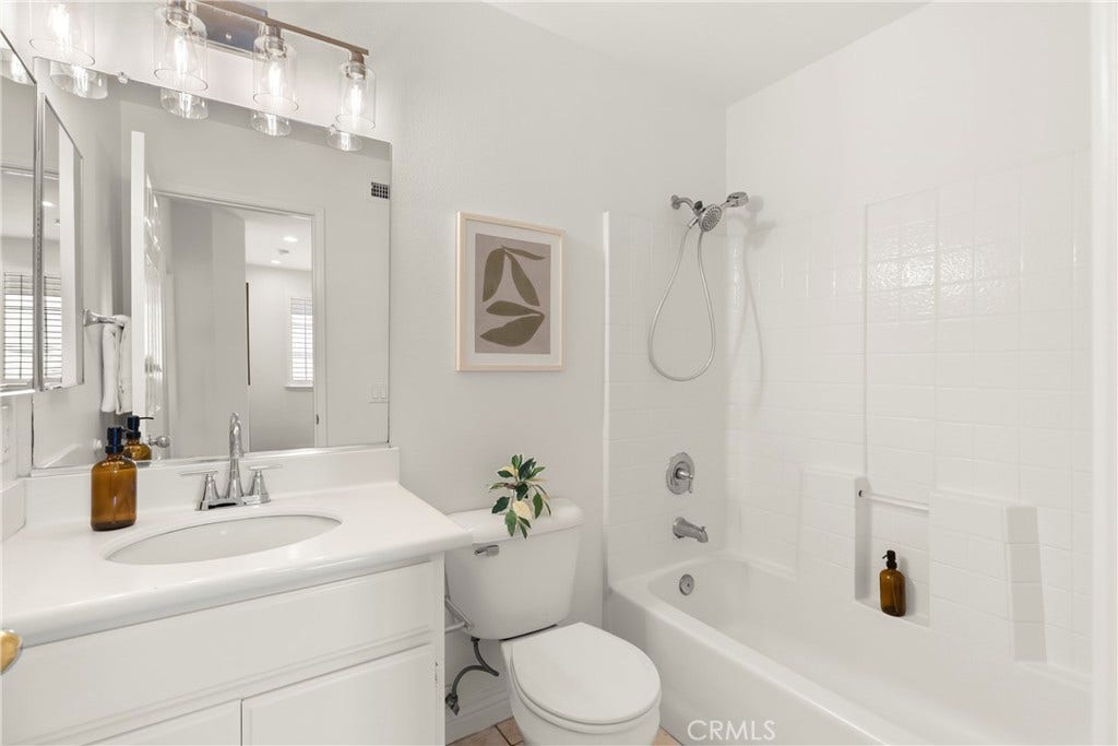 15 Poppyfield, Rancho Santa Margarita, CA 92688 The secondary bathroom features a clean, bright design with a single sink vanity and a shower and tub combination, providing a comfortable and functional space for family and guests.