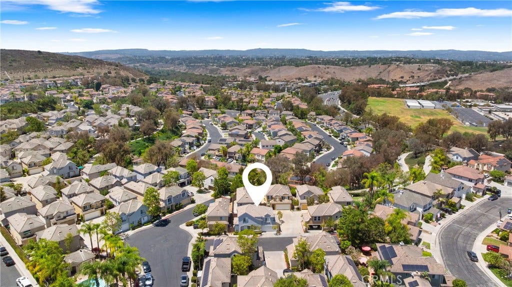 15 Poppyfield, Rancho Santa Margarita, CA 92688 Ideally situated within the community, this home enjoys a prime location just moments from resort-style amenities, scenic walking trails, parks, and highly rated schools, all surrounded by picturesque rolling hills.