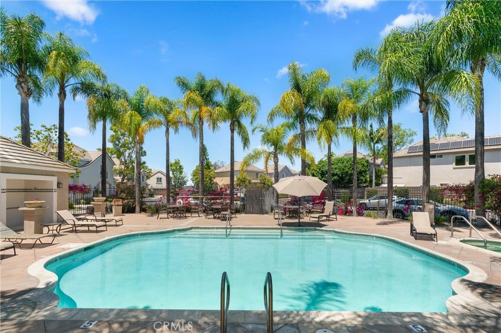 15 Poppyfield, Rancho Santa Margarita, CA 92688 Residents enjoy access to resort style community amenities including a sparkling pool, relaxing spa, and beautifully maintained gathering areas surrounded by mature palm trees, creating the perfect place to unwind and enjoy Southern California living.