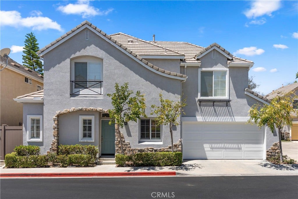 15 Poppyfield, Rancho Santa Margarita, CA 92688 Beautiful corner residence showcasing attractive stone accents, mature landscaping, an attached two-car garage, and timeless curb appeal in the desirable Las Flores community.