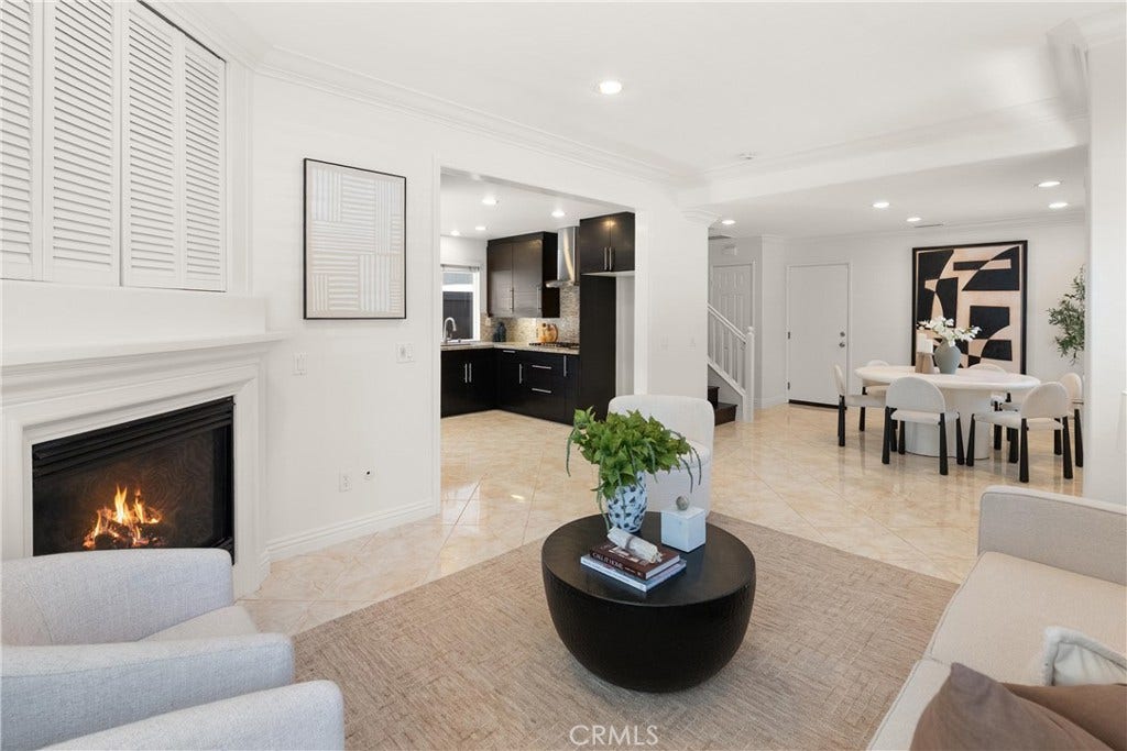 15 Poppyfield, Rancho Santa Margarita, CA 92688 Open-concept layout seamlessly connects the living room, kitchen, dining area, and staircase, creating an ideal setting for both everyday living and entertaining.