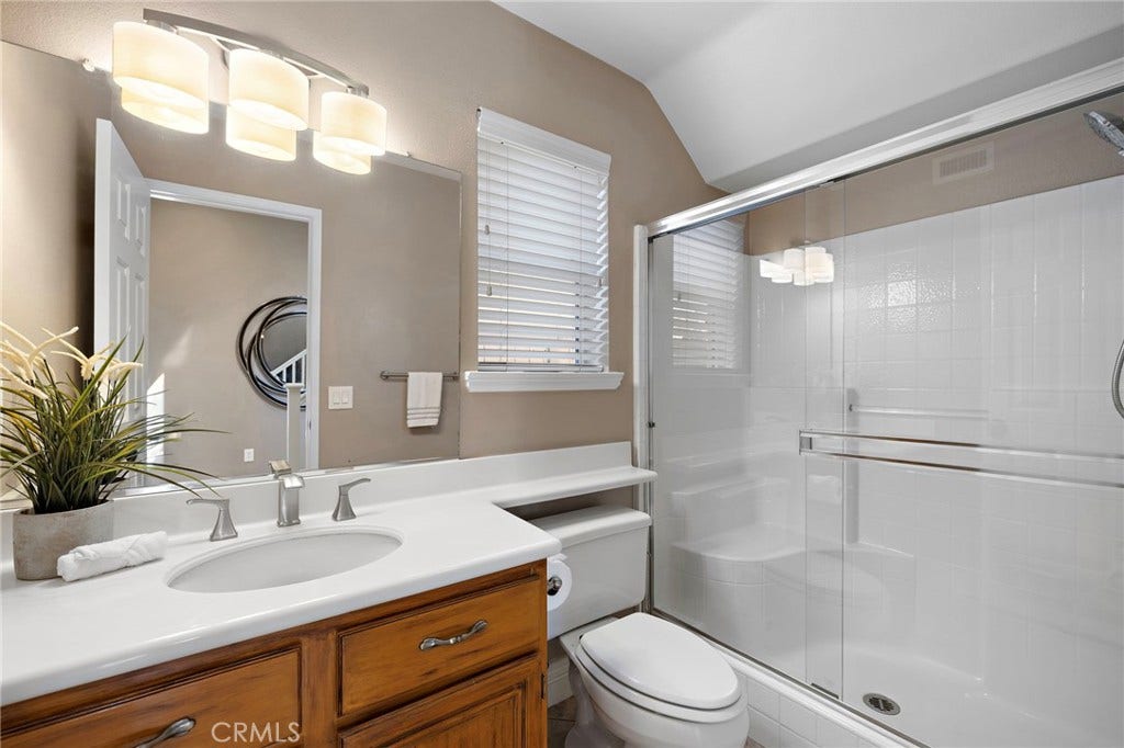 27 Las Cruces, Rancho Santa Margarita, CA 92688 The downstairs bathroom is situated next to the bedroom and offers a vanity for storage and a shower.