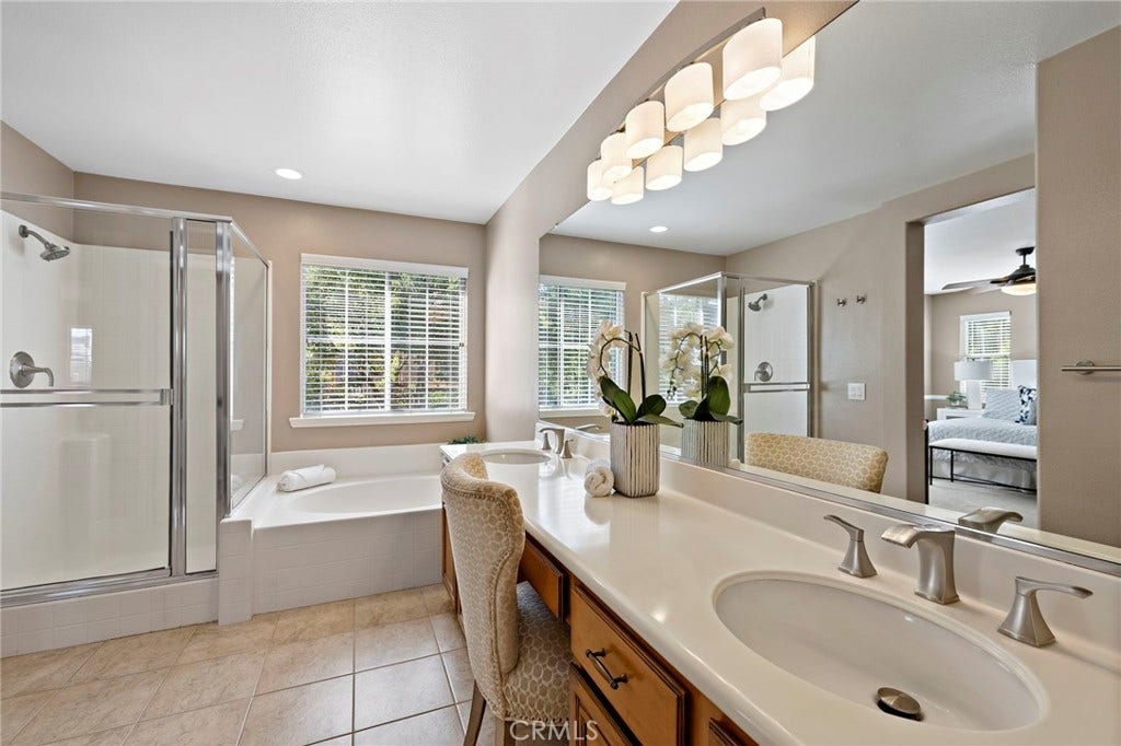 27 Las Cruces, Rancho Santa Margarita, CA 92688 The spotless primary bathroom offers dual sinks, a vanity area and separate soaking tub and shower. The second closet which is a walk-in is conveniently located.