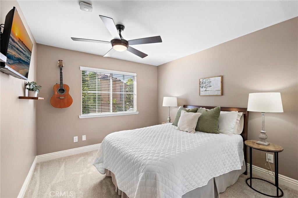 27 Las Cruces, Rancho Santa Margarita, CA 92688 Large secondary upstairs bedroom with a mirrored wardrobe and ceiling fan to keep you cool when it's warm outside.