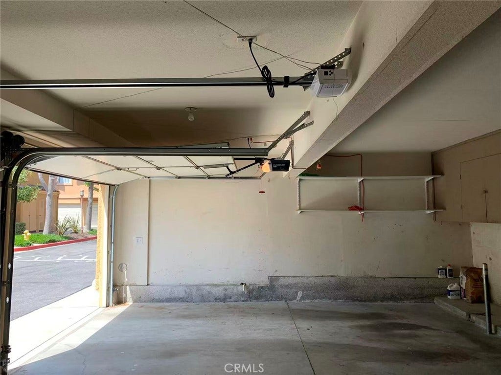 Garage with cabinet and end unit shelves.