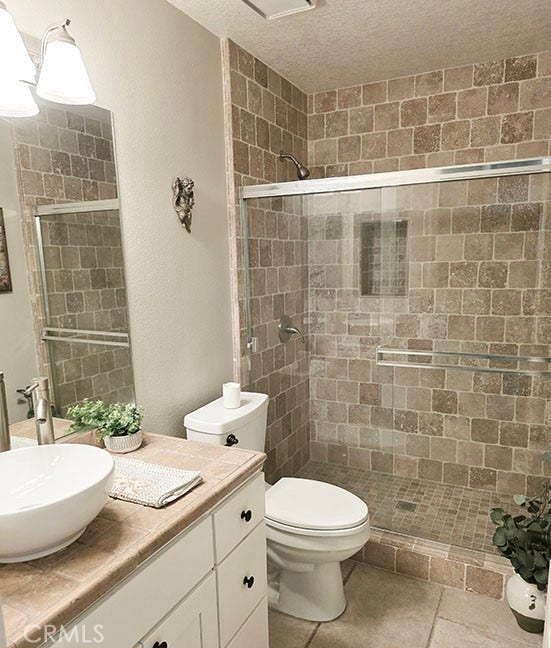 55 Fleurance, Laguna Niguel, CA 92677 Main level full bathroom with a custom step in shower, upgraded lighting, and a vestibule sink