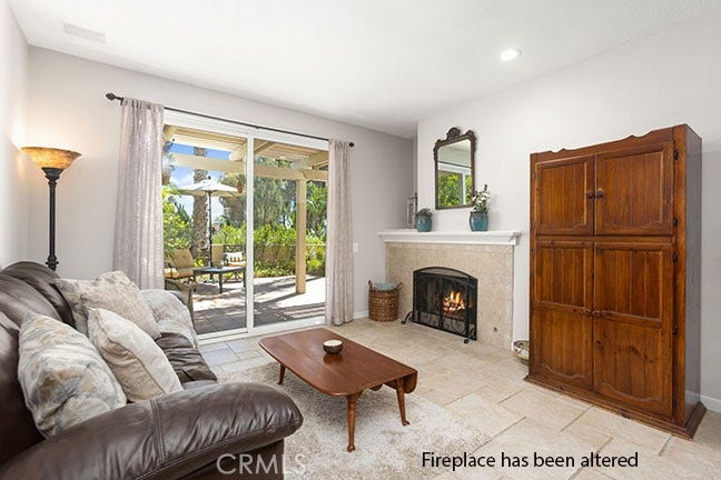 55 Fleurance, Laguna Niguel, CA 92677 Living room with a fireplace and of view of the beautiful back yard